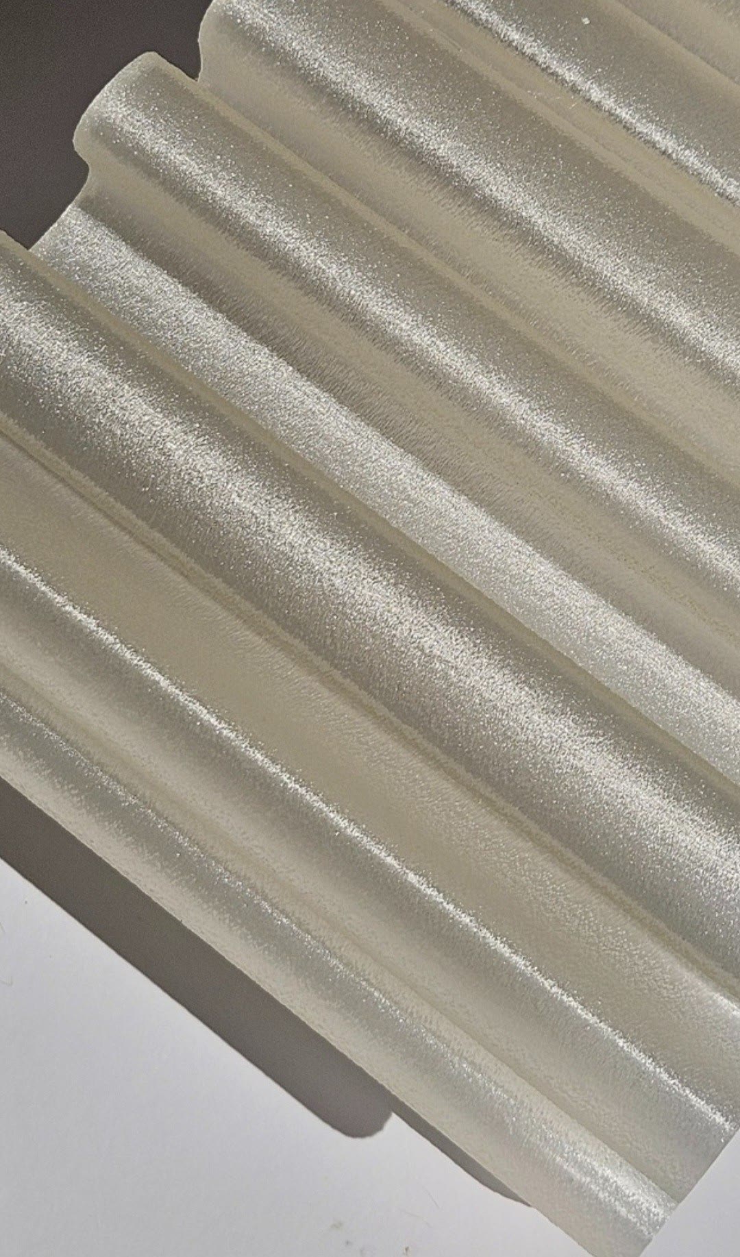 Close-up of a lamp's fluted, softly glittering surface